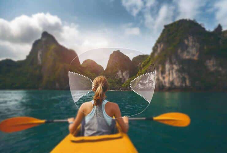 Outline of a varifocal lens showing the soft-focus zones, superimposed over a woman kayaking to some karst islands.